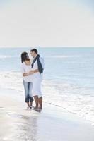 happy young couple have fun at beautiful beach photo