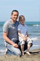 happy father and son have fun and enjoy time on beach photo