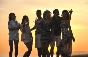 Group of young people enjoy summer  party at the beach photo