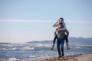 couple having fun at beach during autumn photo