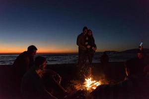 Friends having fun at beach on autumn day photo