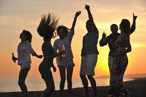 Group of young people enjoy summer  party at the beach photo