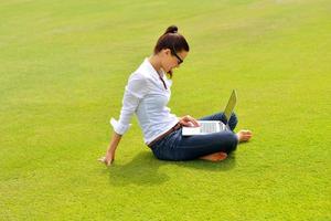 woman with laptop in park photo