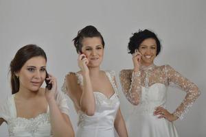 portrait of a three beautiful woman in wedding dress photo