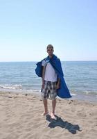 funny superhero standing on beach photo