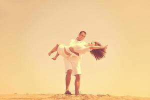 happy young couple have fun on beach photo