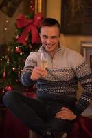 Happy young man with a glass of champagne photo