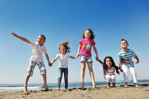 happy young  people group have fun on beach photo