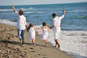 happy young  family have fun on beach photo