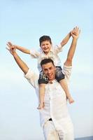 happy young family have fun on beach photo