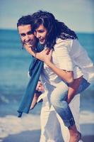 happy young couple have fun at beautiful beach photo