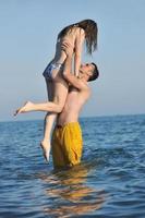 happy young couple have romantic time on beach photo