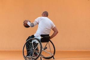 disabled war veterans in action while playing basketball on a basketball court with professional sports equipment for the disabled photo