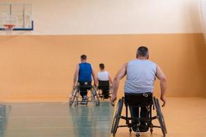 photo of wheelchairs and handicapped war veterans playing basketball on the court