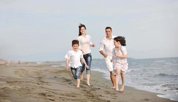 happy young family have fun on beach photo