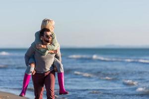 couple having fun at beach during autumn photo