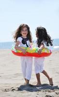 happy child group playing  on beach photo