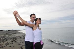 happy young couple have fun at beautiful beach photo