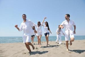 happy people group have fun and running on beach photo