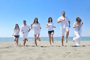 happy young  people group have fun on beach photo