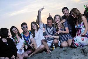 Group of young people enjoy summer  party at the beach photo