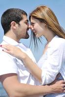 happy young couple have fun on beach photo