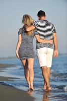 happy young couple have romantic time on beach photo
