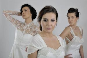 portrait of a three beautiful woman in wedding dress photo