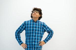 portrait of smart looking arab teenager with glasses wearing a hat in casual school look isolated on white copy space photo