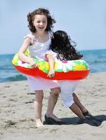 happy child group playing  on beach photo