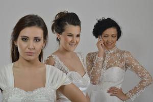 portrait of a three beautiful woman in wedding dress photo