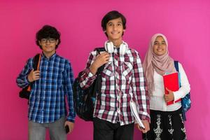 A group of Arab teenagers, a student team walking forward into the future and back to school the concept of a pink background. The concept of successful education for young people. Selective focus photo