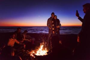 Friends having fun at beach on autumn day photo