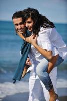 happy young couple have fun at beautiful beach photo