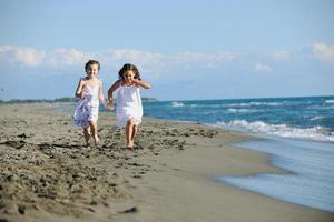 cute little girls running on beach photo