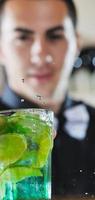 pro barman prepare coctail drink on party photo