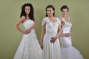 portrait of a three beautiful woman in wedding dress photo