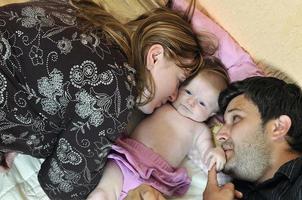 portrait of young family with  cute little babby photo