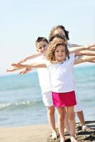 happy child group playing  on beach photo