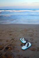 sandals on beach with long exposure photo