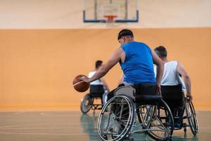 handicapped war veterans in wheelchairs with professional equipment play basketball match in the hall.the concept of sports with disabilities photo