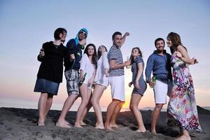 Group of young people enjoy summer  party at the beach photo