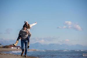 couple having fun at beach during autumn photo