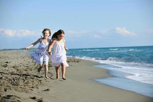 cute little girls running on beach photo