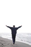 man jogging at beach photo