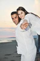 happy young couple have fun on beach photo