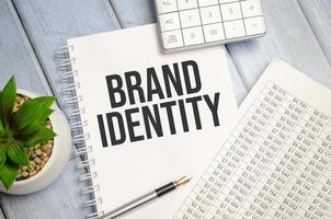 brand identity word on notepad with glasses and chart photo