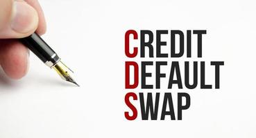 CDS Credit Default Swap - word on a white notebook against the background photo