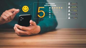 Man using a mobile phone in give rating to service experience on application. Online customer review satisfaction feedback survey. photo