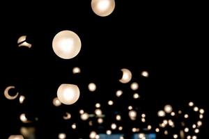 abstract blurred background of lights. Abstract blurry dark indoor plaza hall with a lot of small bokeh photo